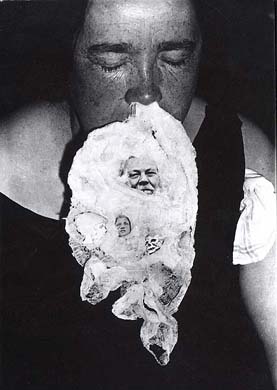 Ectoplasm photographed under seance in the 19th century. Note the small face.
